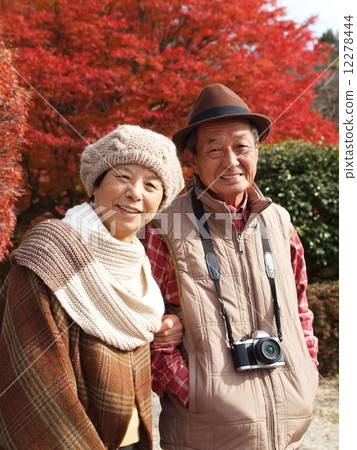 A friend and senior couple who enjoys autumn leaves A friend and senior couple who enjoys autumn leaves 12278444