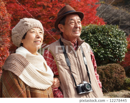 A friend and senior couple who enjoys autumn leaves A friend and senior couple who enjoys autumn leaves 12278445