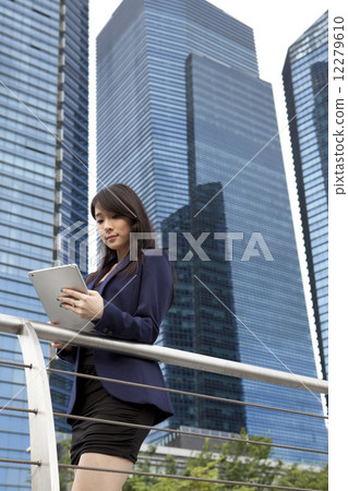 Businesswoman using tablet outdoors Businesswoman using tablet outdoors 12279610