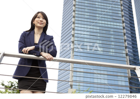 Businesswoman leaning on railing outdoors Businesswoman leaning on railing outdoors 12279846