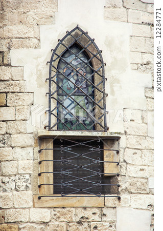 Barred window on church wall Barred window on church wall 12284771
