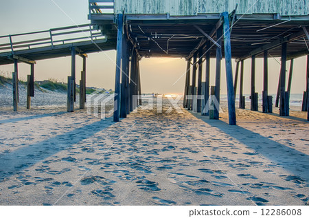 looking under pier towards sandy beach at avon north carolina 12286008