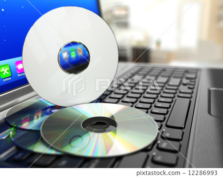 Software CD on laptop keyboard. Compact disks. 12286993