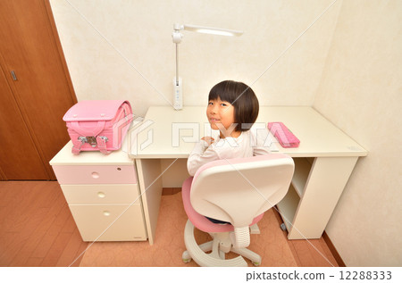 Elementary school girl studying in a children's room Elementary school girl studying in a children's room 12288333