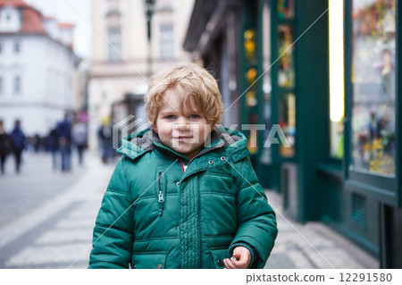 Portrait of little toddler boy walking through the city on cold Portrait of little toddler boy walking through the city on cold 12291580