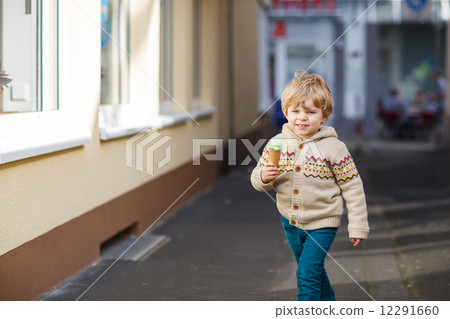 Happy little boy eating ice cream, outdoors Happy little boy eating ice cream, outdoors 12291660