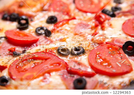 Close-up shot of delicious Italian pizza with ham, tomatoes and 12294363