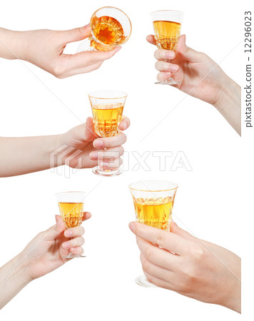 set of hand holds little glass of dessert wine 12296023