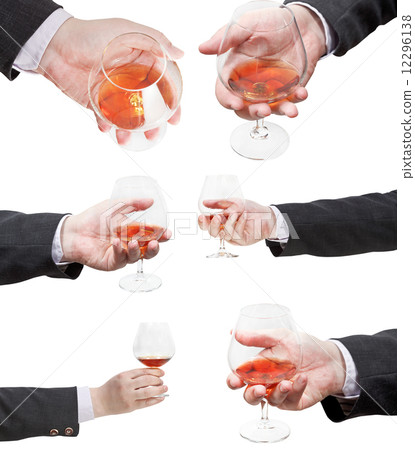 set of brandy glasses in businessman hand 12296138