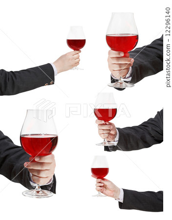 set of red wine glass in businessman hand set of red wine glass in businessman hand 12296140