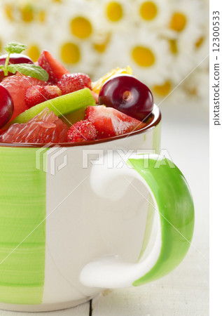 Green cup with fruits 12300533