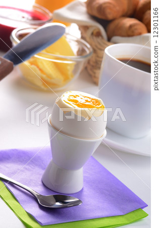 Breakfast of boiled egg croissant jam butter and coffee 12301166