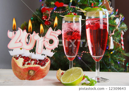Two glasses with red champagne and candles 2015 Two glasses with red champagne and candles 2015 12309643