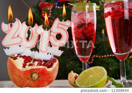 Two glasses with red champagne and candles 2015 Two glasses with red champagne and candles 2015 12309644