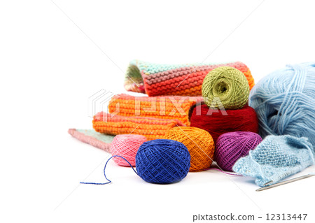 Colored threads and fabric on white background. 12313447