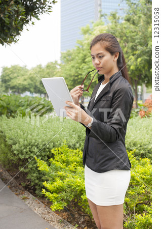 Young businesswoman using a tablet. Young businesswoman using a tablet. 12315058
