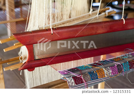 Vintage manual weaving loom with unfinished textile work Vintage manual weaving loom with unfinished textile work 12315331