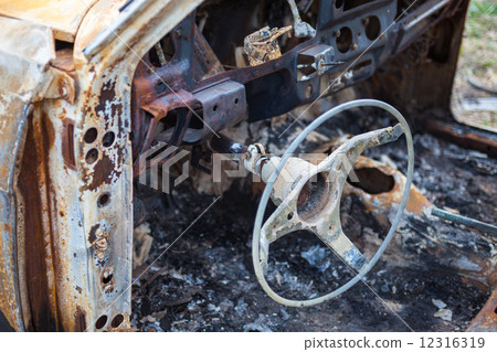 Burnt car interior with steering wheel after the accident Burnt car interior with steering wheel after the accident 12316319