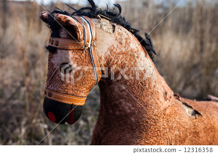 Close-up of the old thrown away rocking horse 12316358