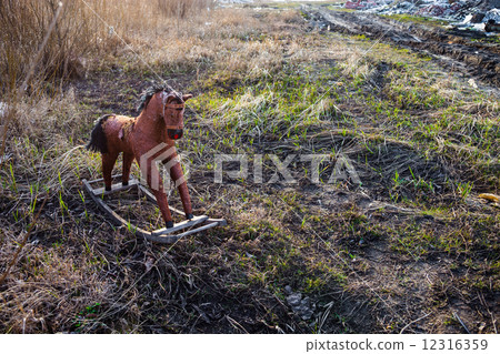Old thrown away rocking horse 12316359