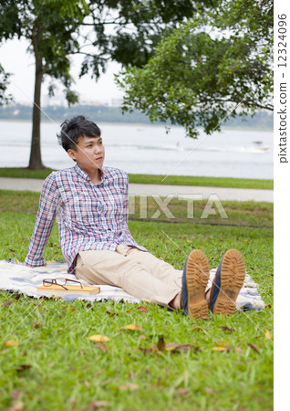 Young guy relaxing in a park. Young guy relaxing in a park. 12324096