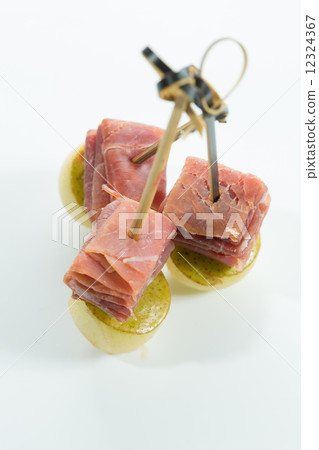 Appetizer. Creative cuisine. Prosciutto with pear on a white background. 12324367
