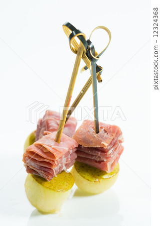 Appetizer. Creative cuisine. Prosciutto with pear on a white background. 12324368