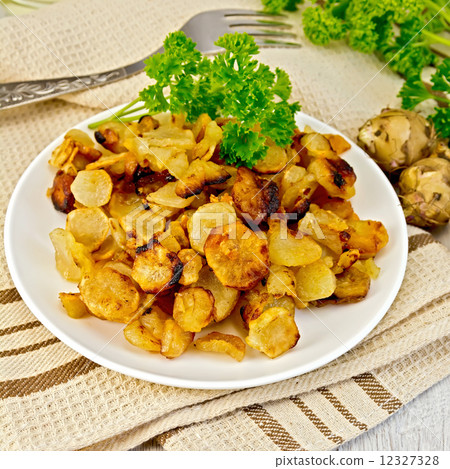 Jerusalem artichokes fried in dish on napkin Jerusalem artichokes fried in dish on napkin 12327328