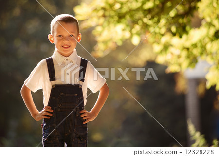 Cute smiling young boy backlit by the sun 12328228
