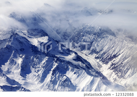 Top view on snow mountains and glacier in mist 12332088