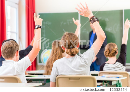 Teacher  educate or teaching a class of  pupils in school 12332354