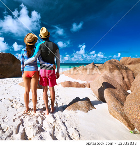 Couple at tropical beach wearing rash guard 12332838
