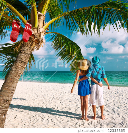 Couple in blue clothes on a beach at christmas 12332865