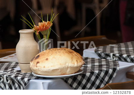Cafe table with cake on plate and pitcher Cafe table with cake on plate and pitcher 12332878