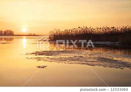 Winter landscape with river and sunset fiery sky. Beautiful wint Winter landscape with river and sunset fiery sky. Beautiful wint 12333069