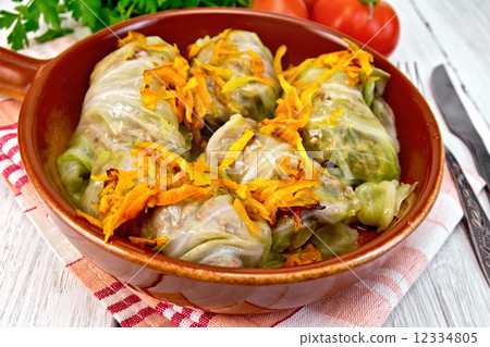 Cabbage stuffed with sauerkraut in ceramic pan on board 12334805