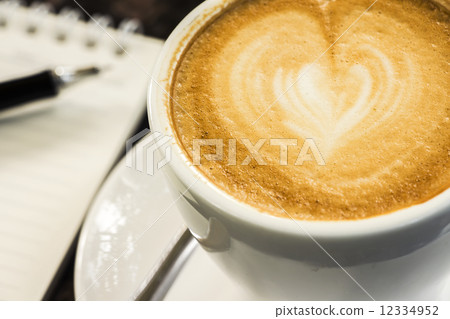 Open a blank white notebook, pen and cup of coffee on marble des Open a blank white notebook, pen and cup of coffee on marble des 12334952