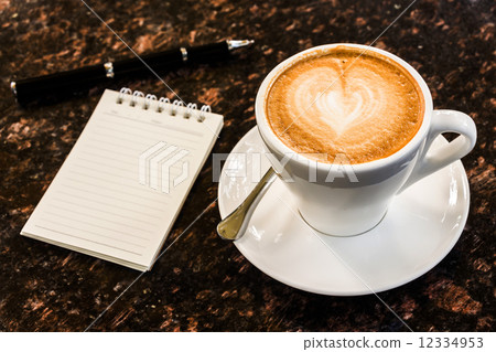 Open a blank white notebook, pen and cup of coffee on marble des Open a blank white notebook, pen and cup of coffee on marble des 12334953