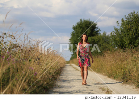Woman walking on the road 12341119