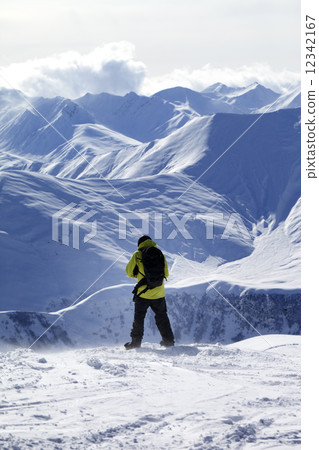 Snowboarder on top of off-piste slope 12342167