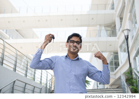 Young Asian Indian estate agent or salesman holding a key, India Young Asian Indian estate agent or salesman holding a key, India 12342994