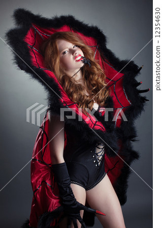 Redhead girl posing in fashionable spider costume Redhead girl posing in fashionable spider costume 12354630