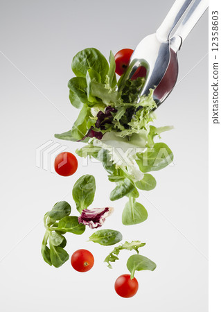 fresh salad falling from a clamp 12358603