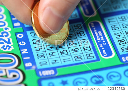 Woman scratching lottery ticket called Bingo.  12359580