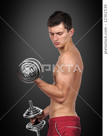 muscular man lifting dumbbells 12362530
