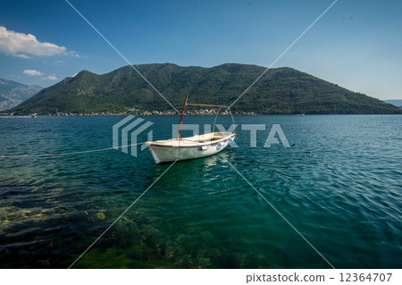 Kotor bay with moored white wooden rowboat Kotor bay with moored white wooden rowboat 12364707