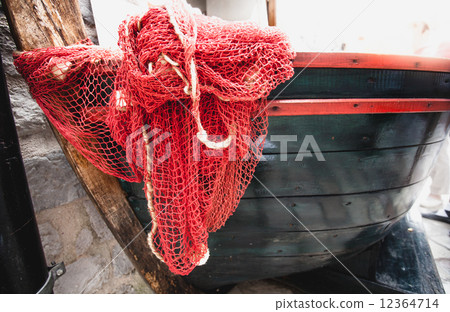 red fishnet lying blue wooden rowboat red fishnet lying blue wooden rowboat 12364714
