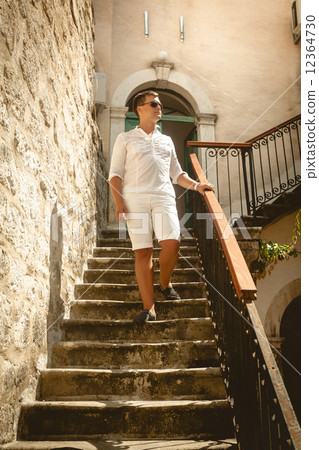 man walking down the old stone staircase at sunny day man walking down the old stone staircase at sunny day 12364730