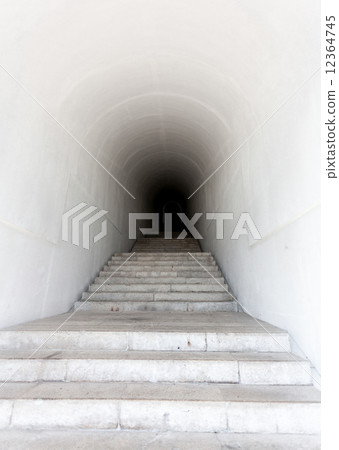 marble staircase leading to dark tunnel 12364745