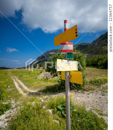 signpost with different directions standing on start of tourist 12364757